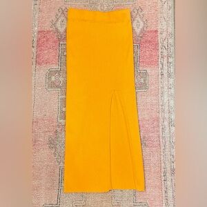 Tangerine mid length with slit skirt and elastic band. NWOT.